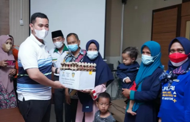 Bupati Pangkep Muhammad Yusran Lalogau saat menyerahkan bantuan paket makanan tambahan untuk penanganan stunting di Aula Dinas Kesehatan Pangkep, Sulawesi Selatan,